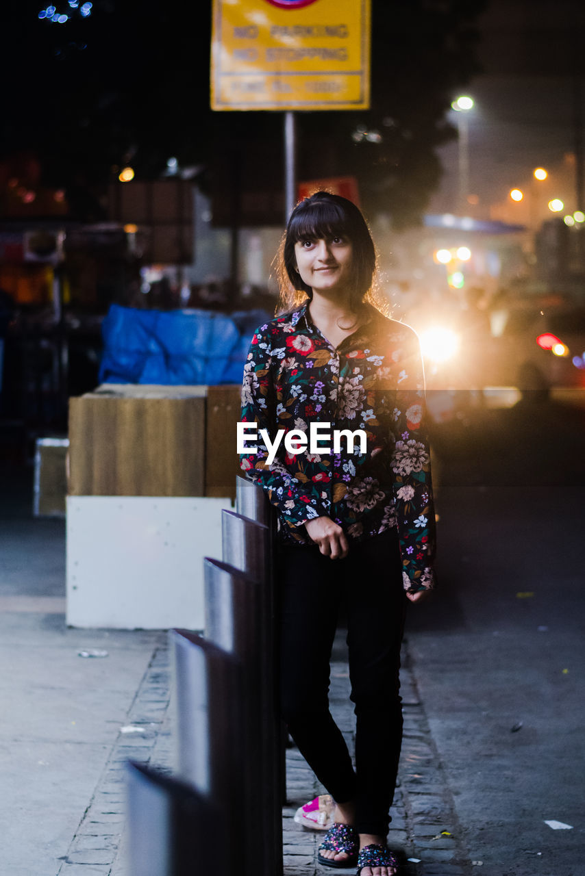 Full length of woman standing in city