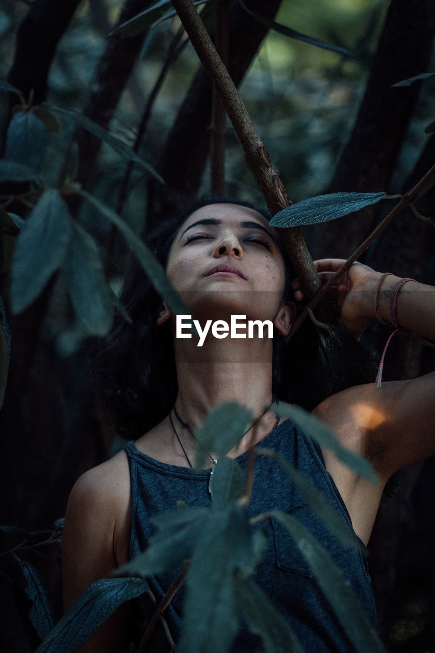 Close-up of woman amidst plants