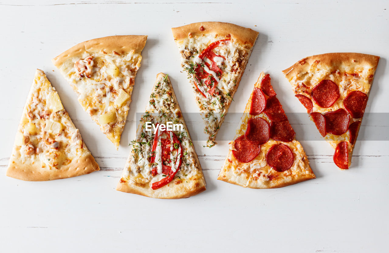 High angle view of pizza on table against white background