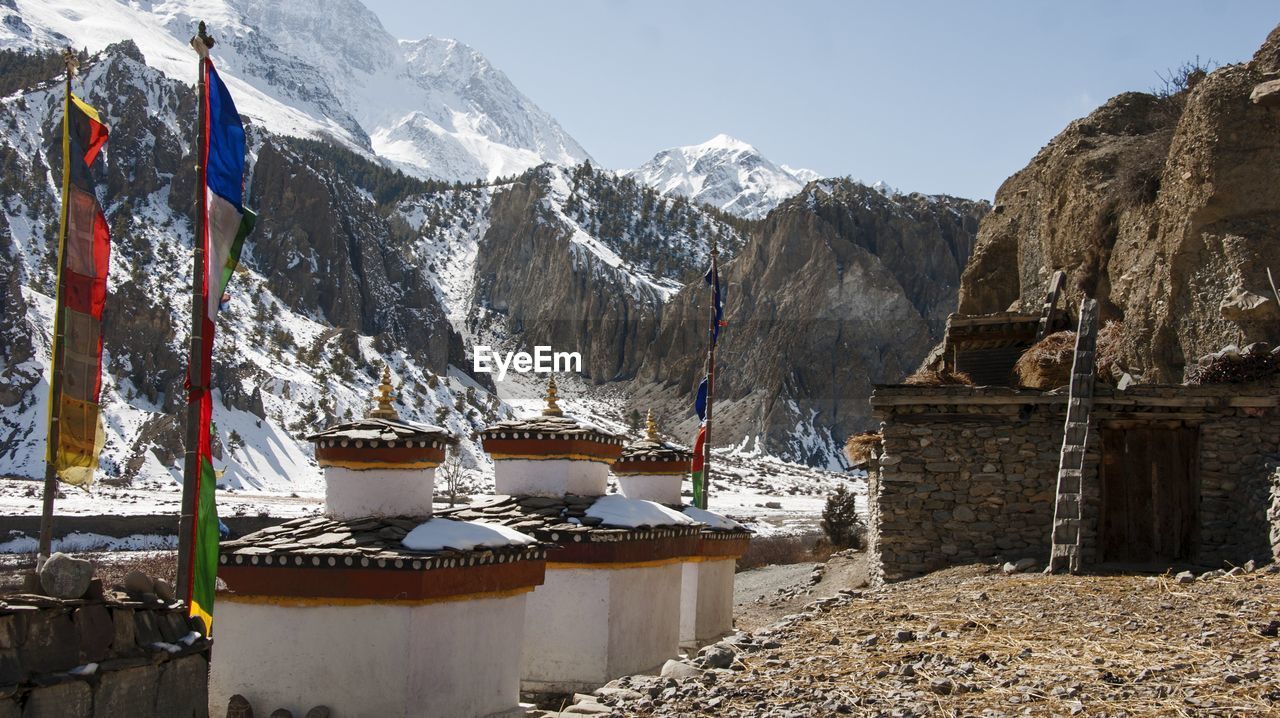 Panoramic shot of mountains against clear sky during winter