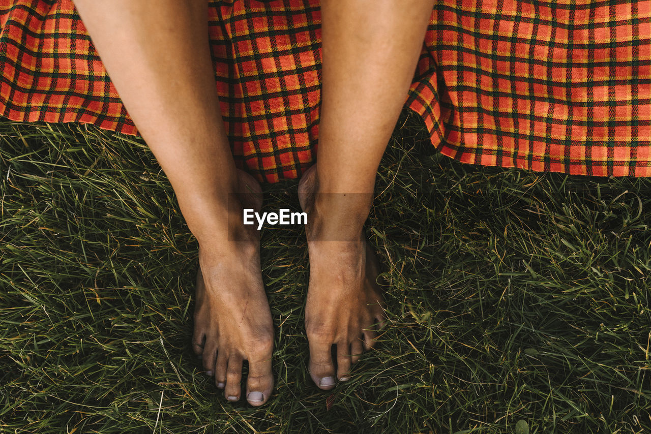 High angle view of bare feet on grass barefoot