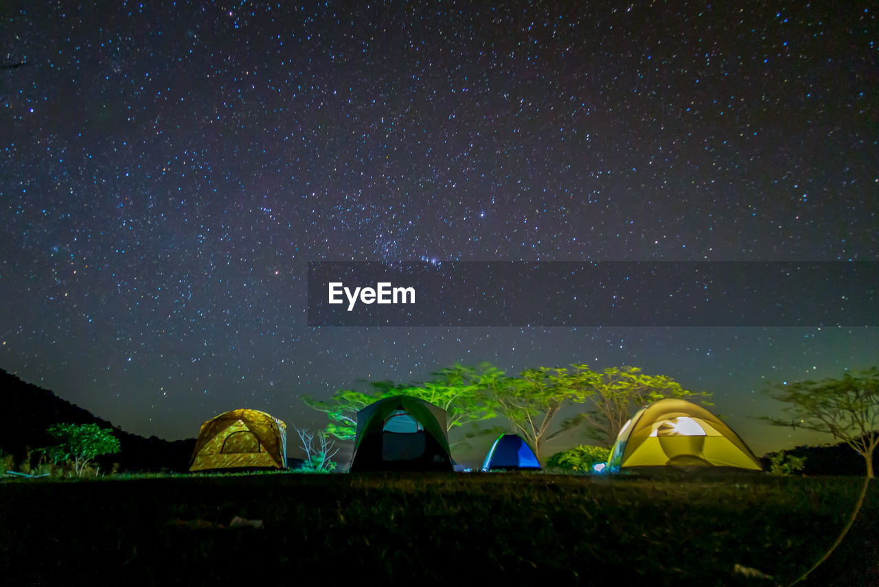 Tent on field against sky at night