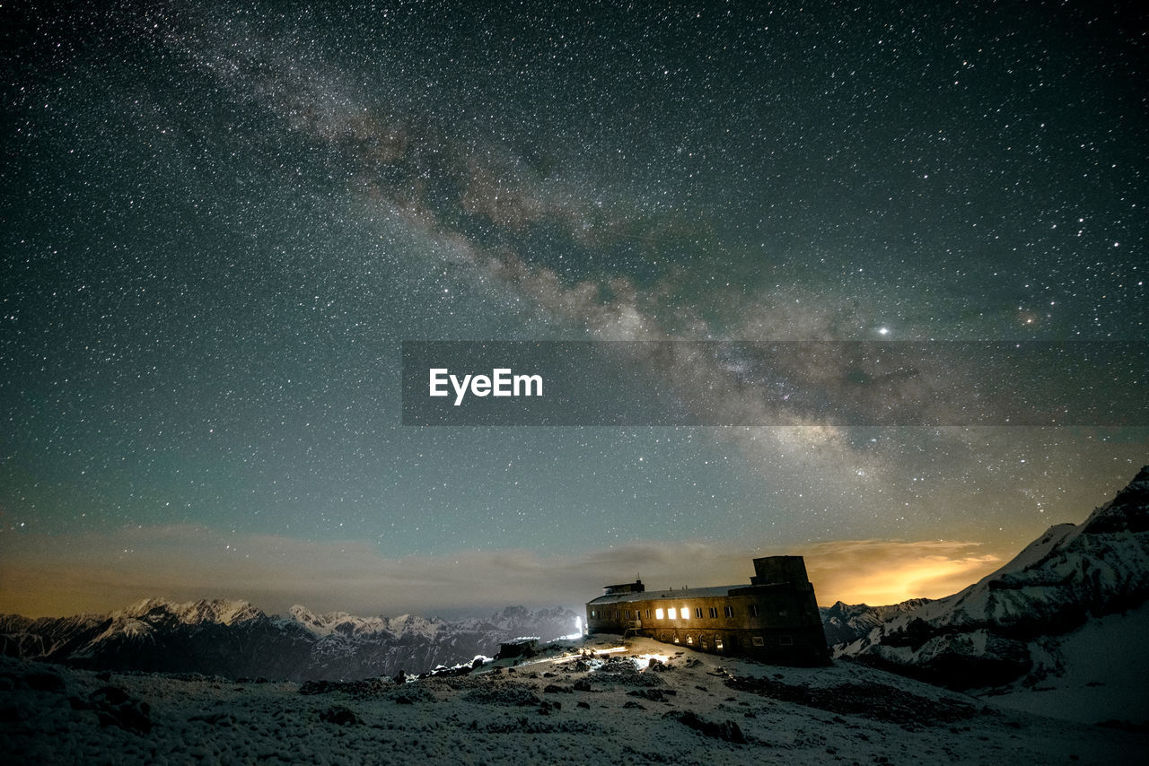 Scenic view of illuminated mountain against sky at night