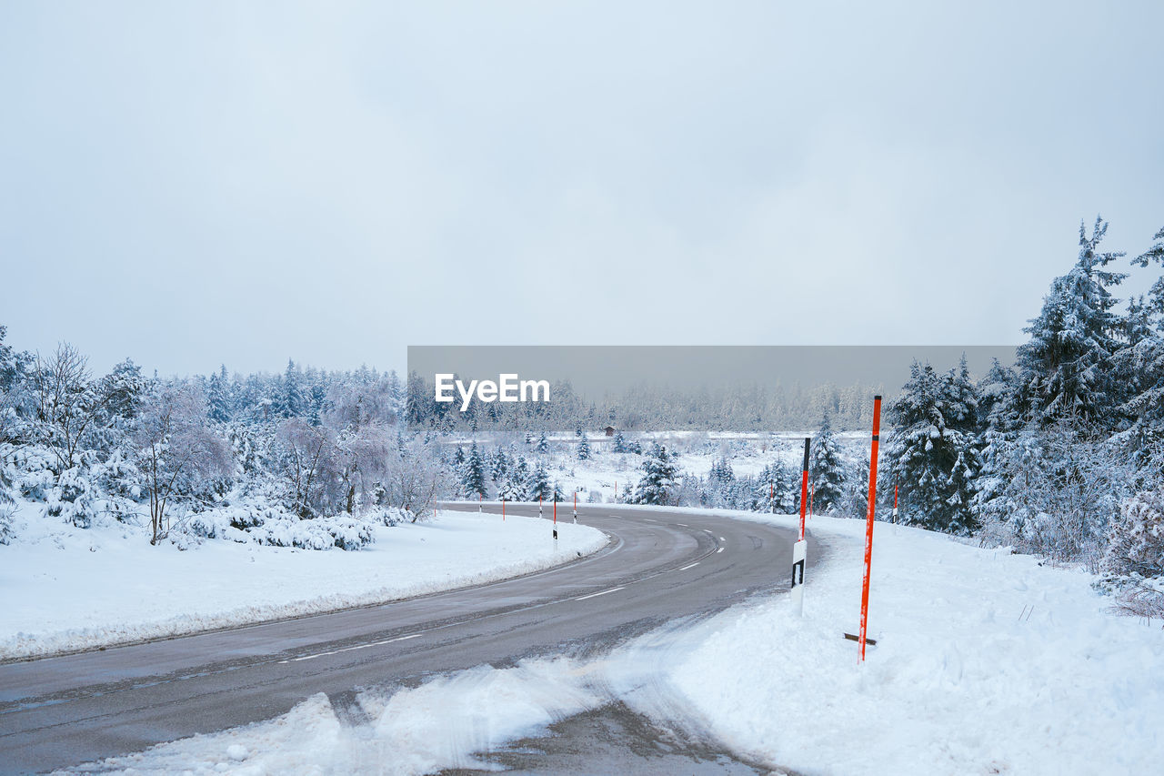 Curvy mountain road in an snowcapped icy scenery