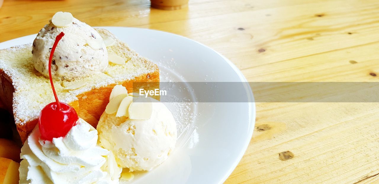 High angle view of icecream with bread  on table