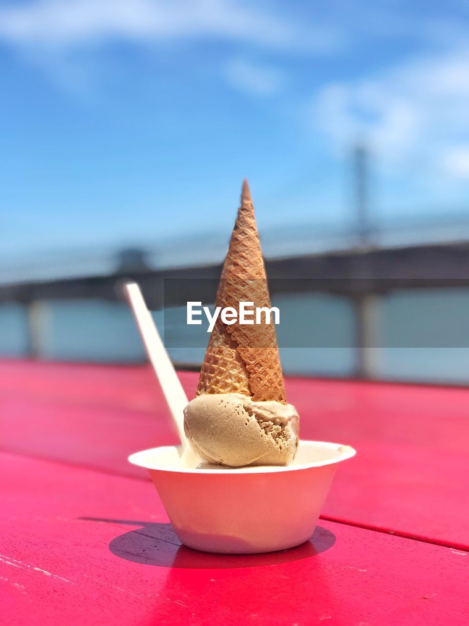 CLOSE-UP OF ICE CREAM ON WOODEN TABLE