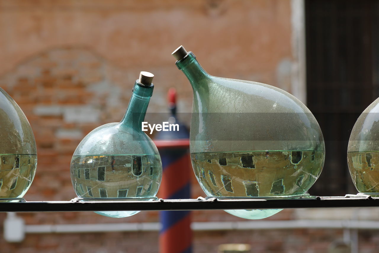 Close-up of glass bottles filled with water