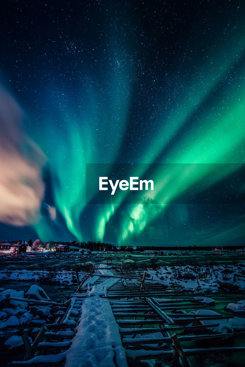 Scenic view of snowcapped landscape against sky at night