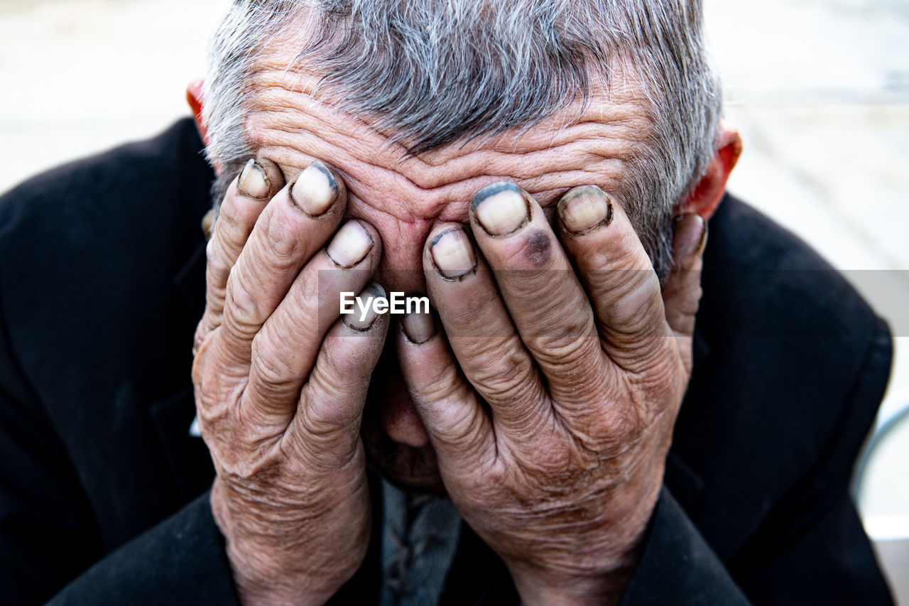 CLOSE-UP OF MAN WITH HANDS