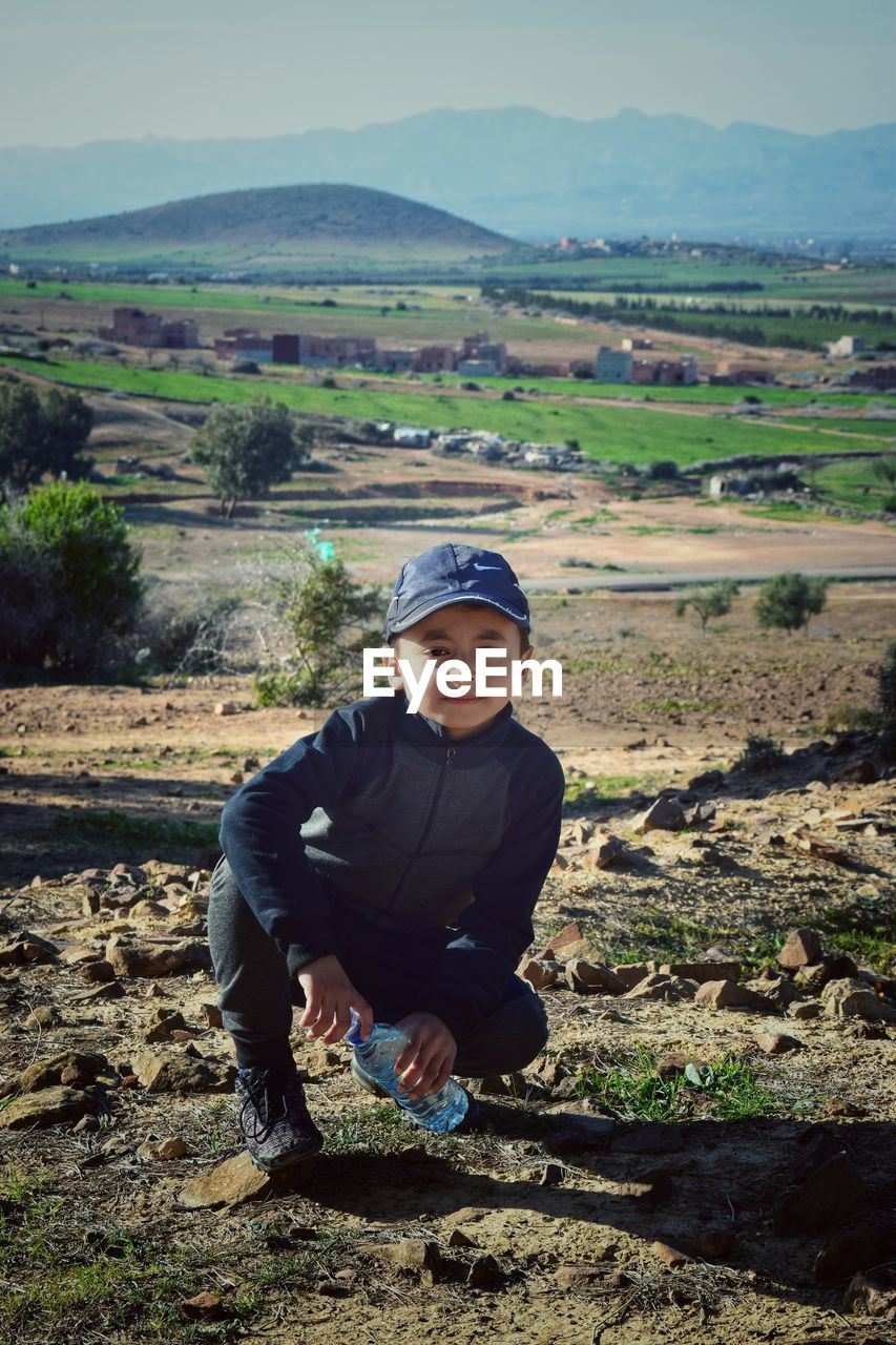 PORTRAIT OF BOY ON LAND