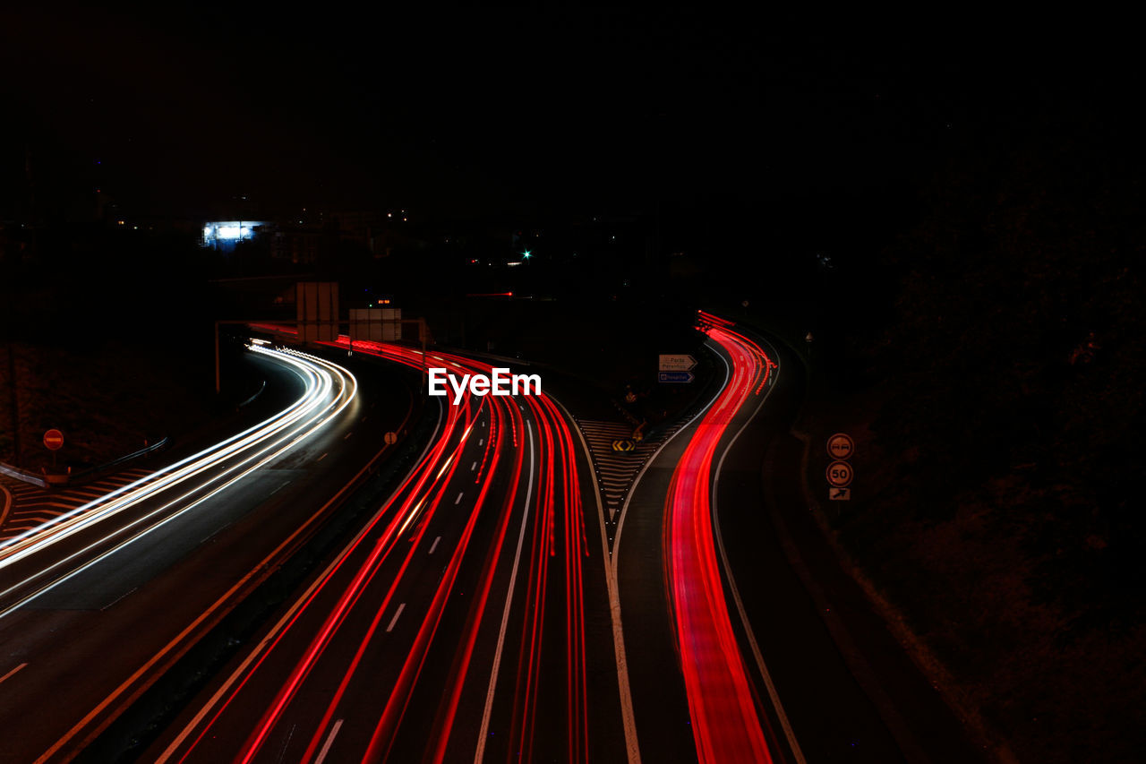 High angle view of light trails on road at night