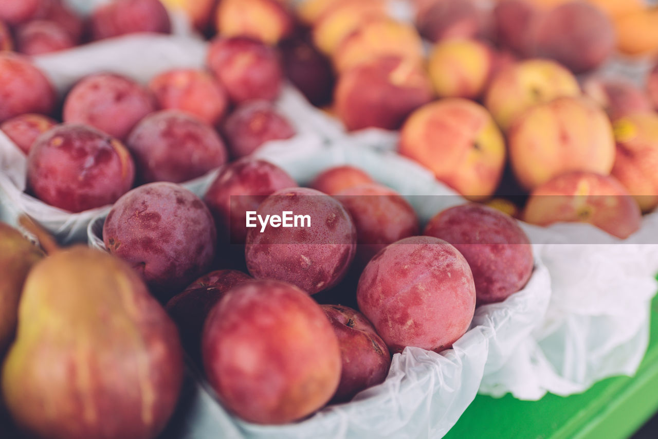 Close-up of plums for sale at market stall