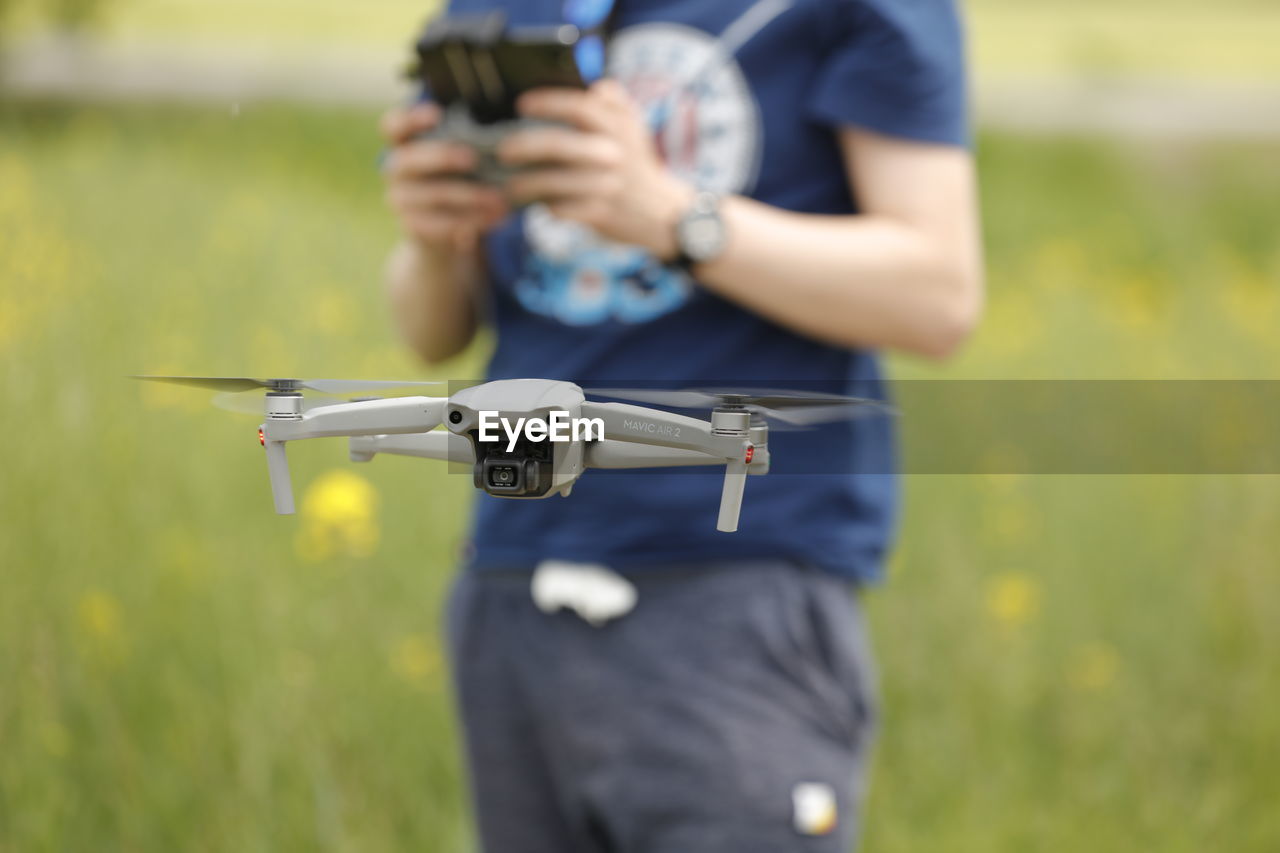 Man photographing on field