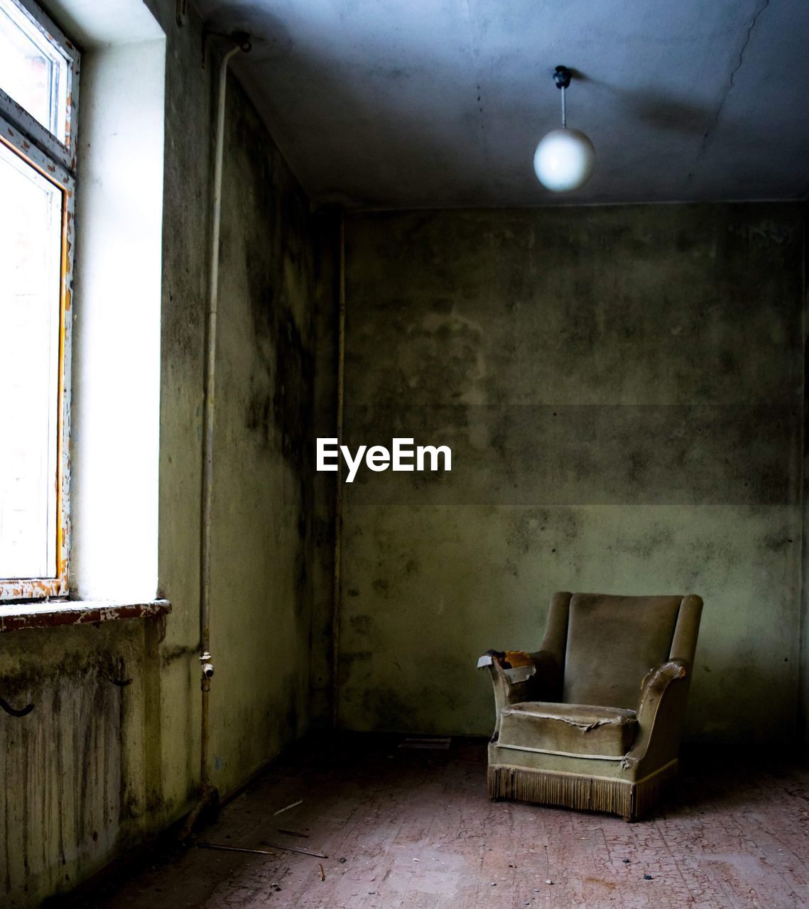 EMPTY CHAIRS IN ABANDONED BUILDING