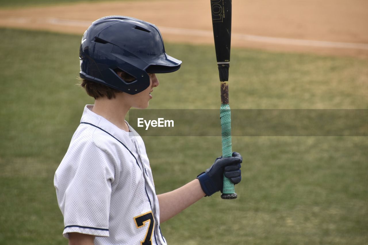 Teen boy playing baseball 