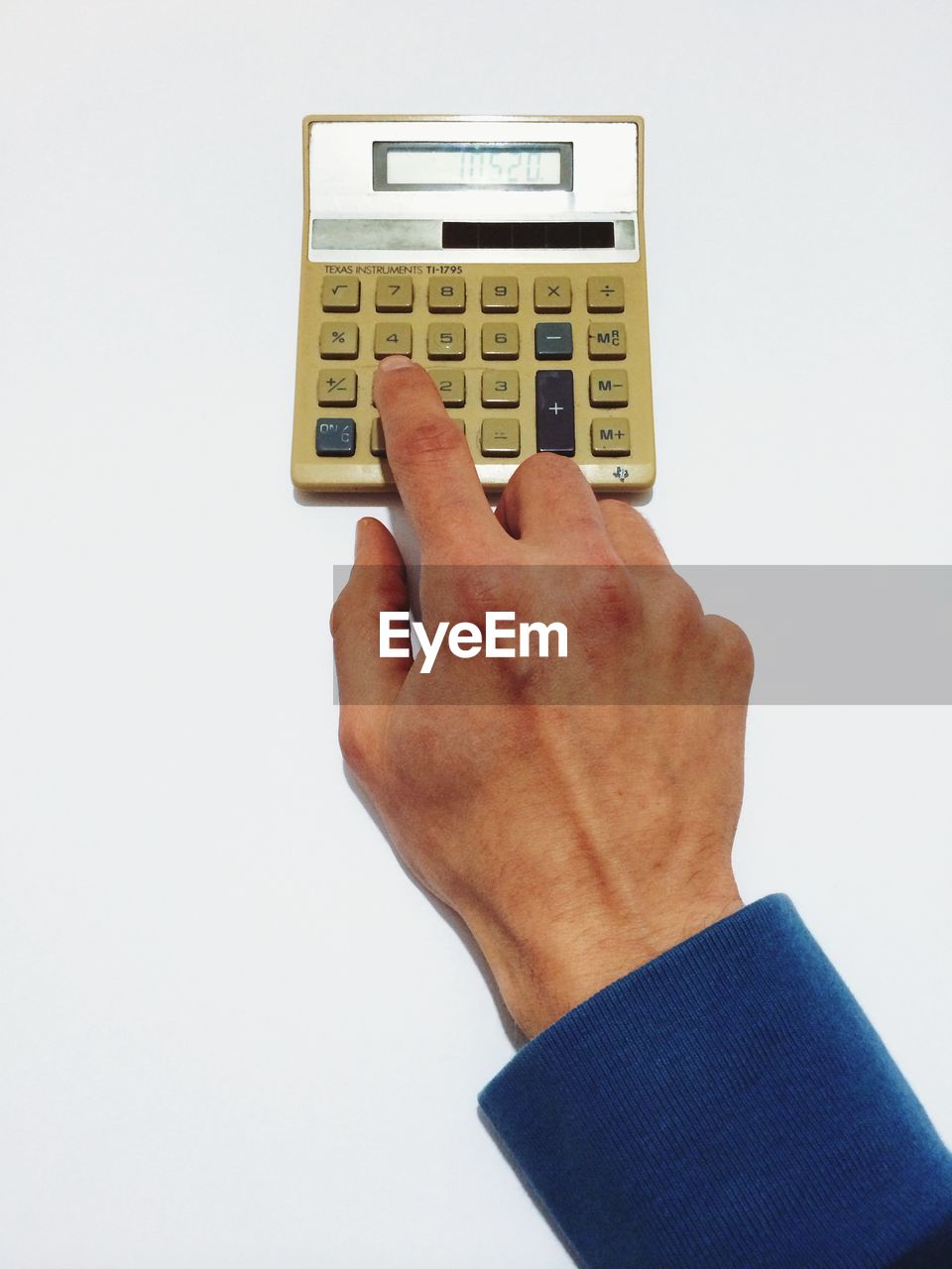 High angle view of man using old calculator against white background