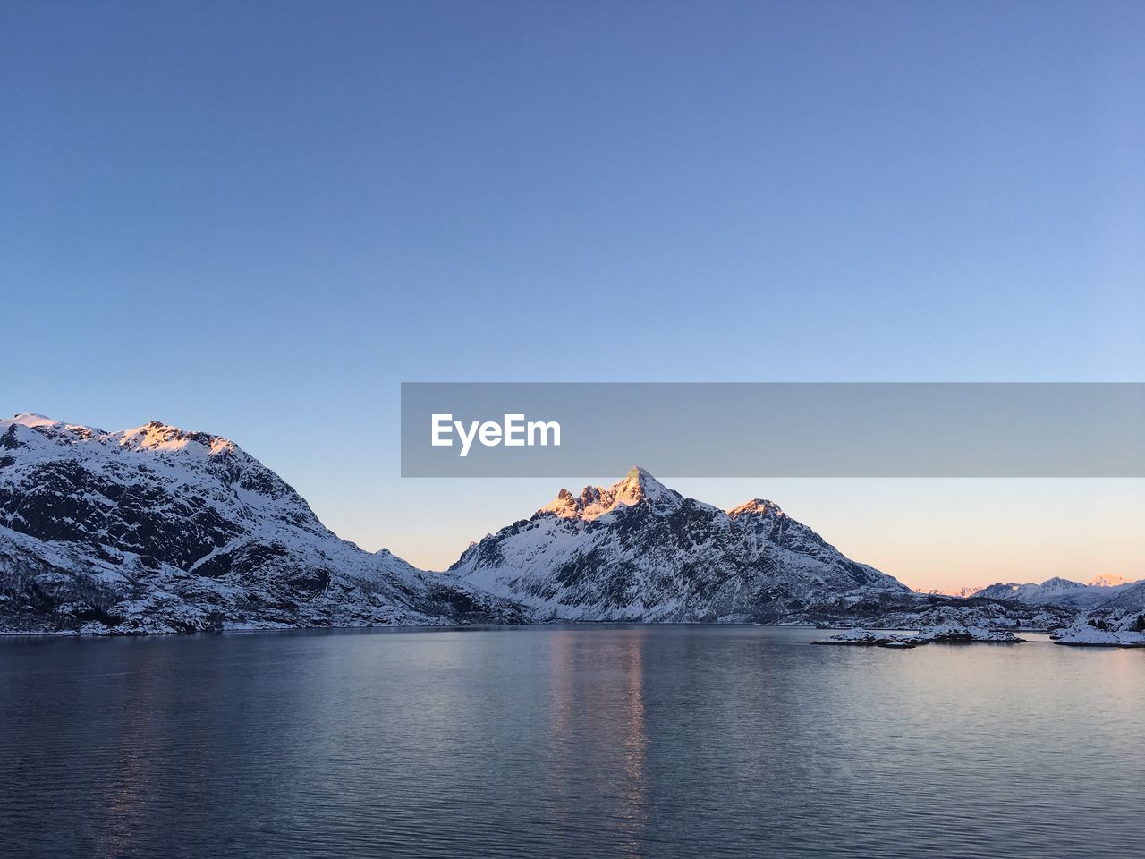 Scenic view of snowcapped mountains against clear sky