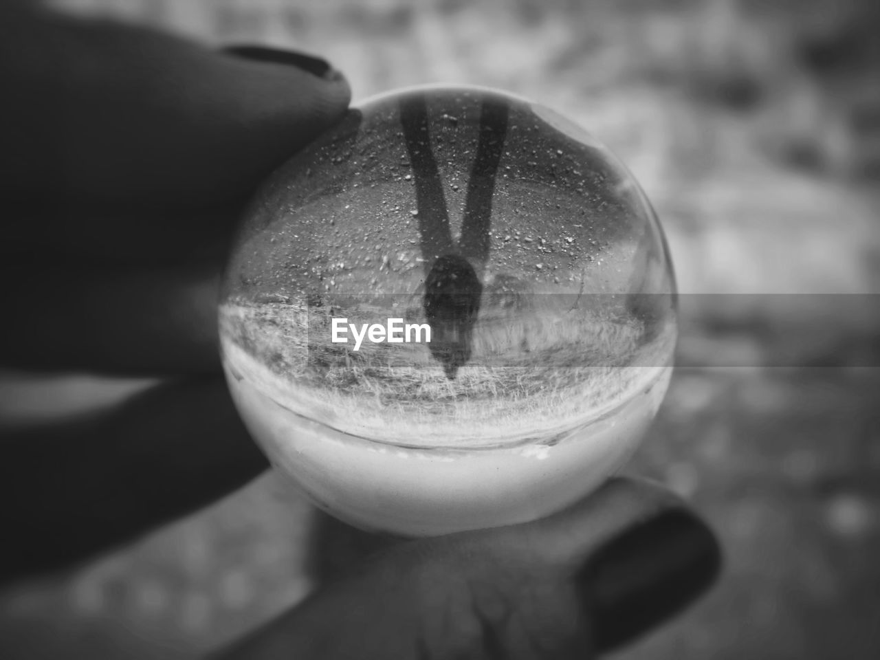 Close up view of a crystal ball in a woman's hand