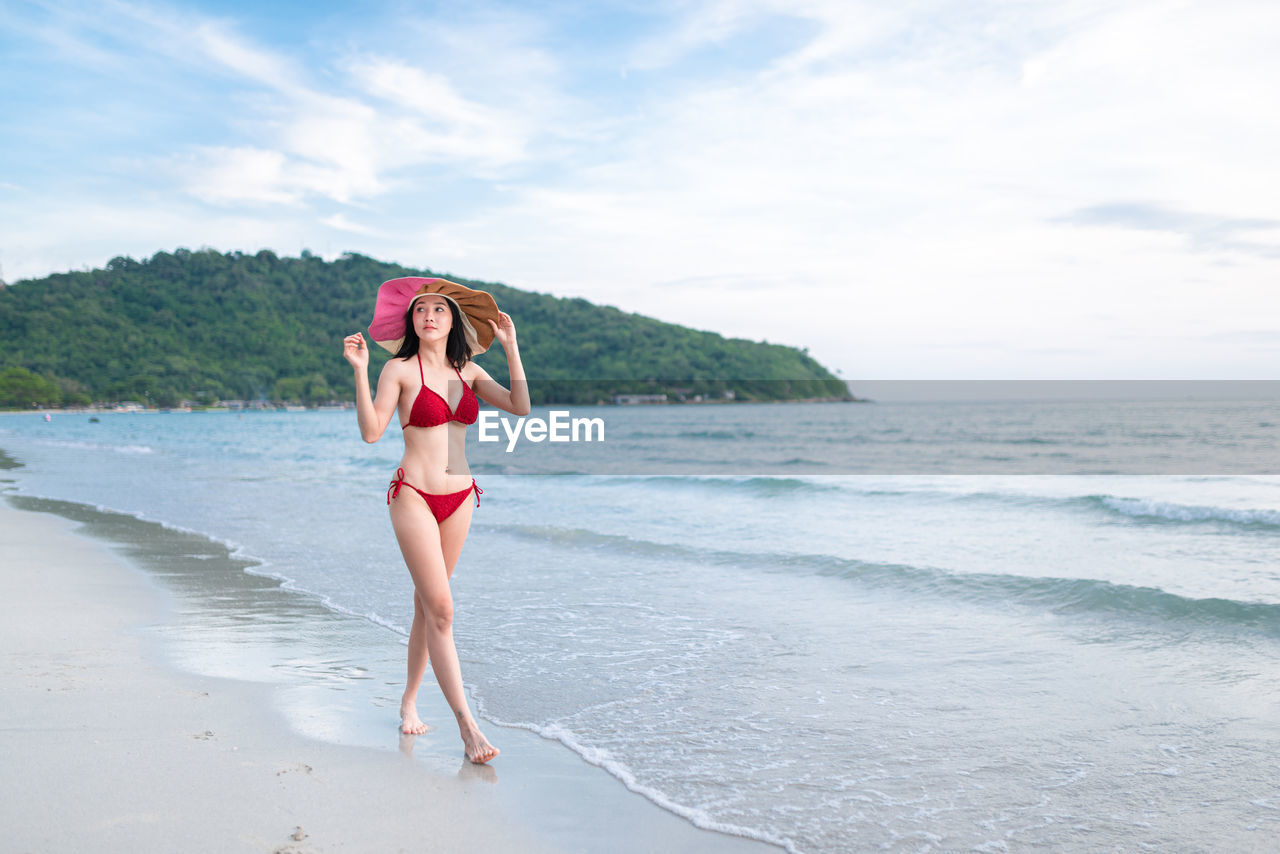 Asian woman relaxing on the beach. bikini summer beach