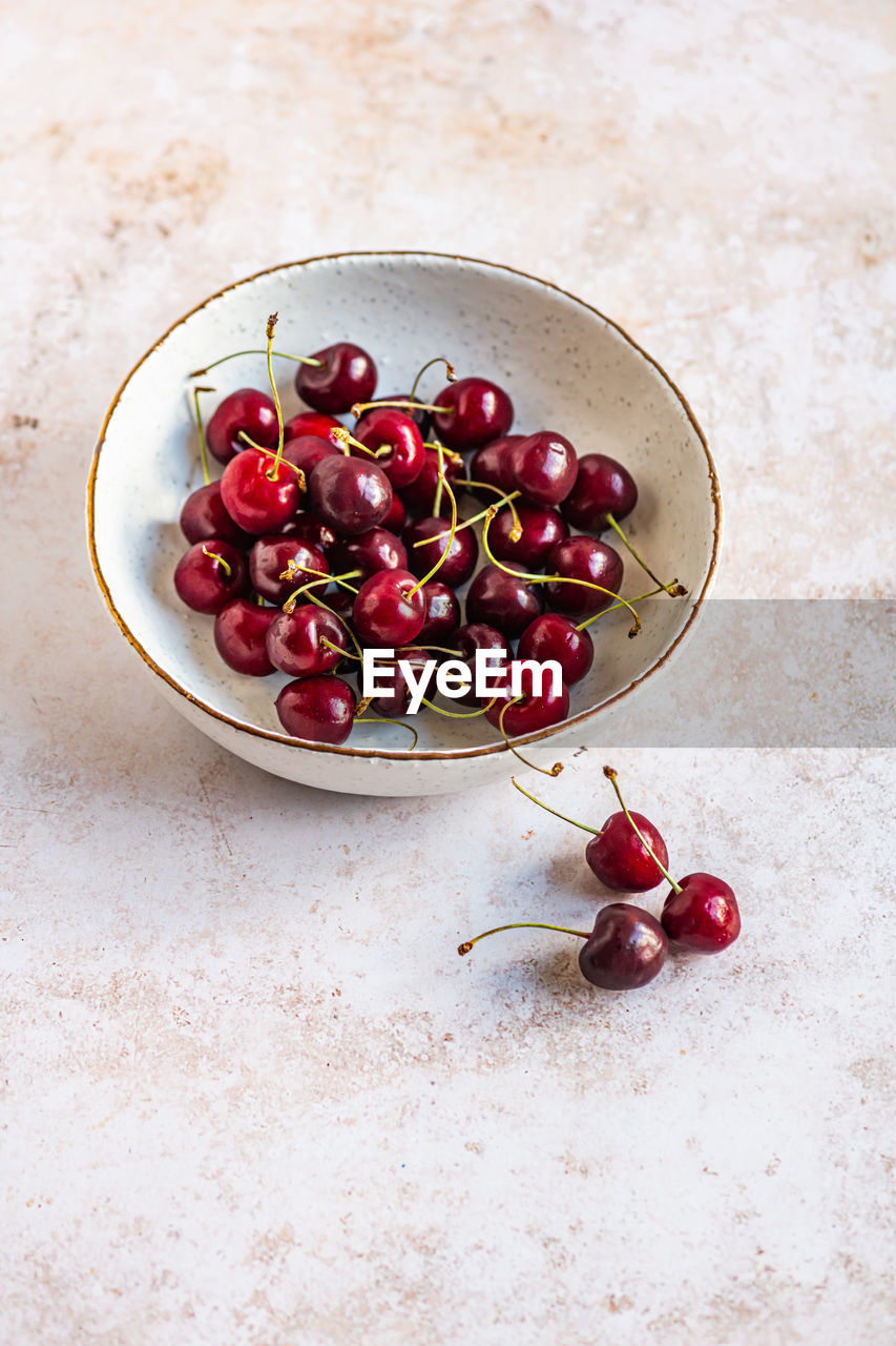 High angle view of cherries in bowl on table