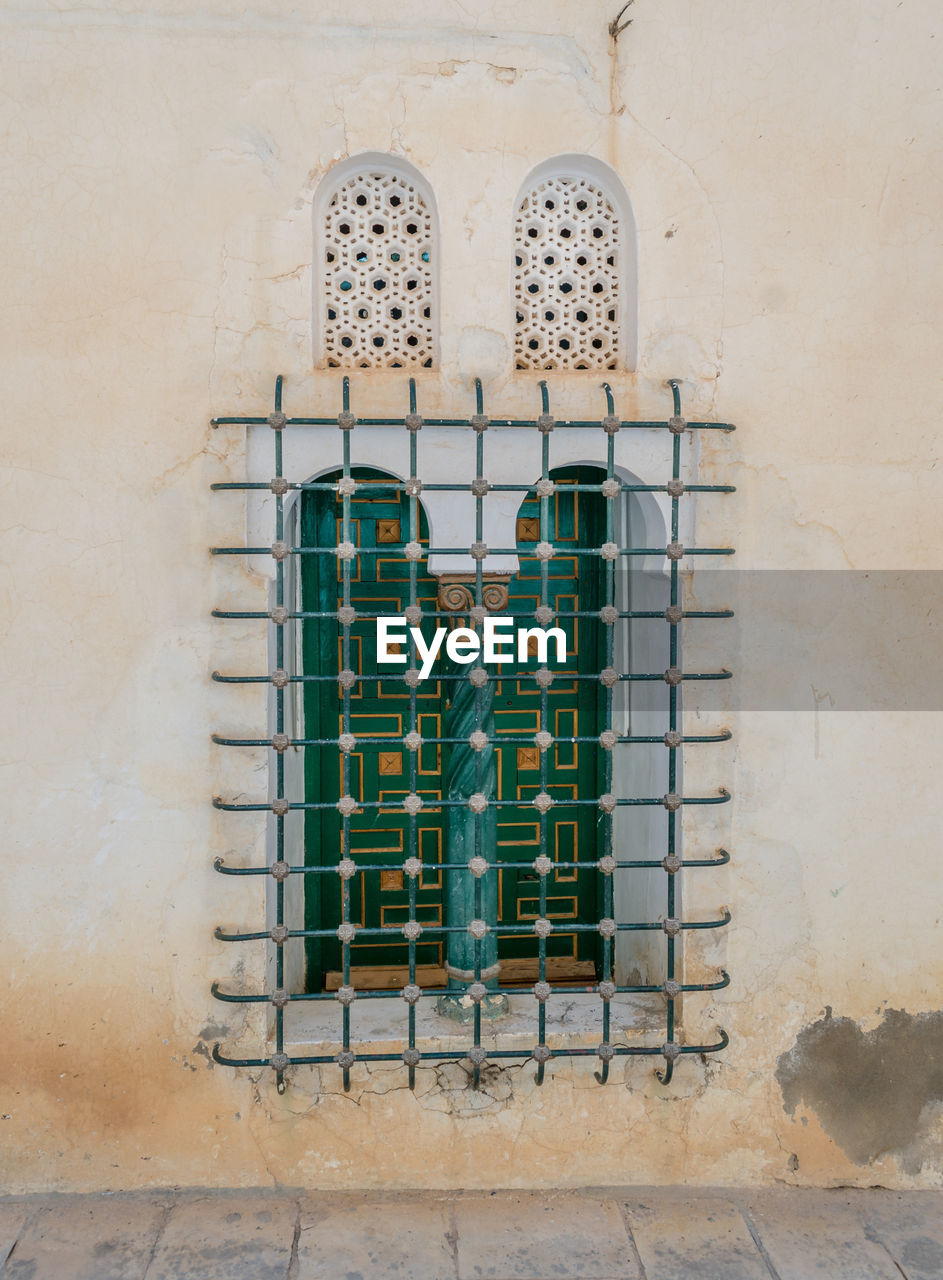 Low angle view of window on wall of building