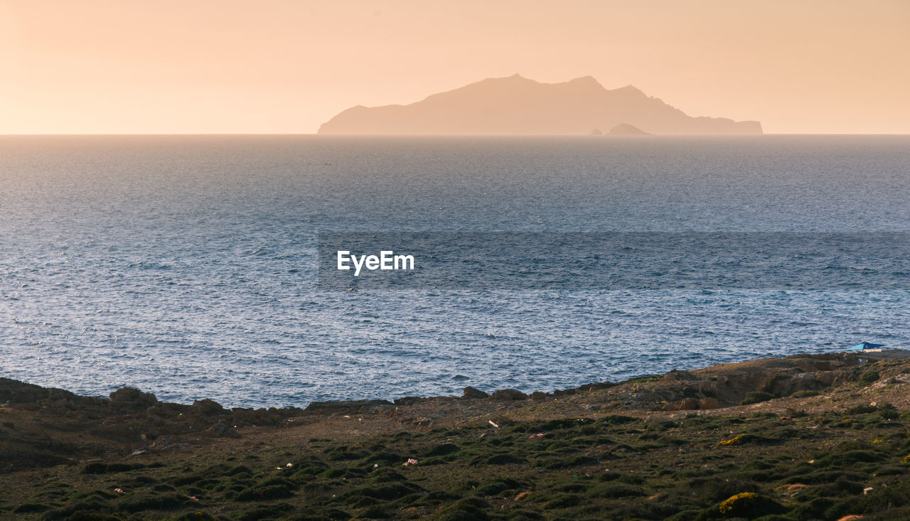 Scenic view of sea against clear sky during sunset