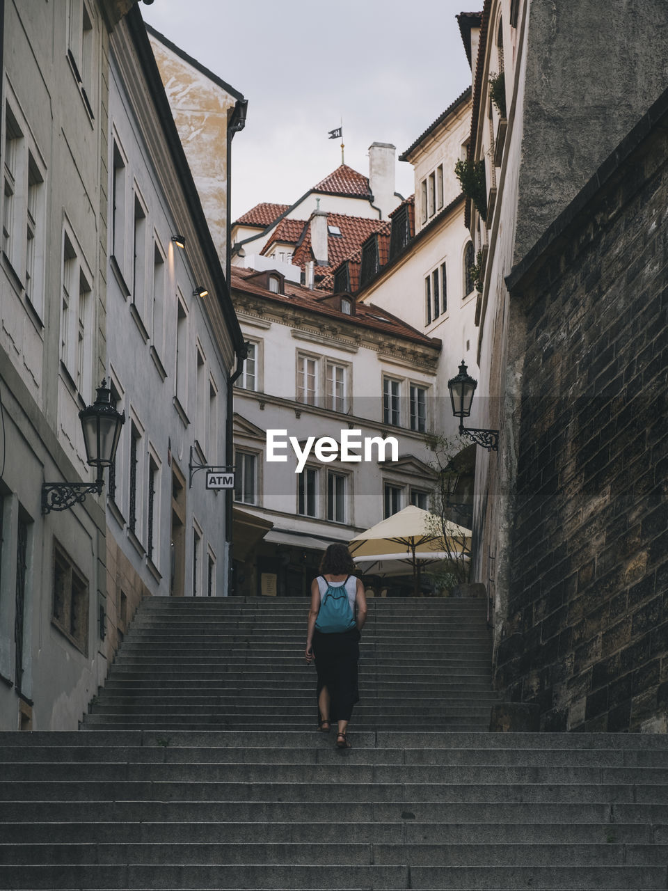 Woman walking through the city of prague, czech republic.