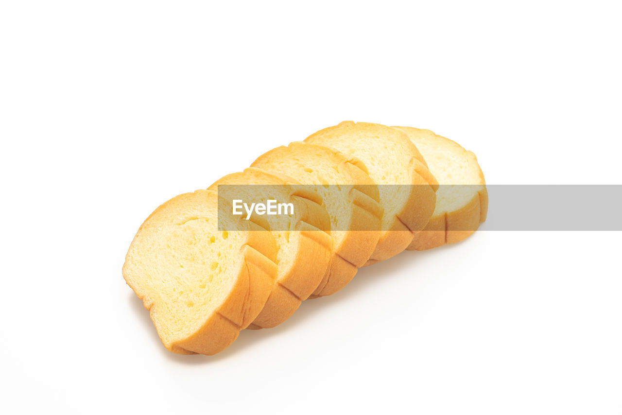 CLOSE-UP OF BREAD OVER WHITE BACKGROUND