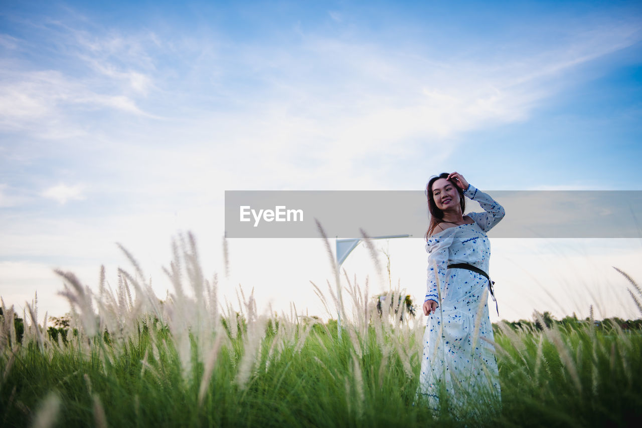 WOMAN STANDING ON FIELD