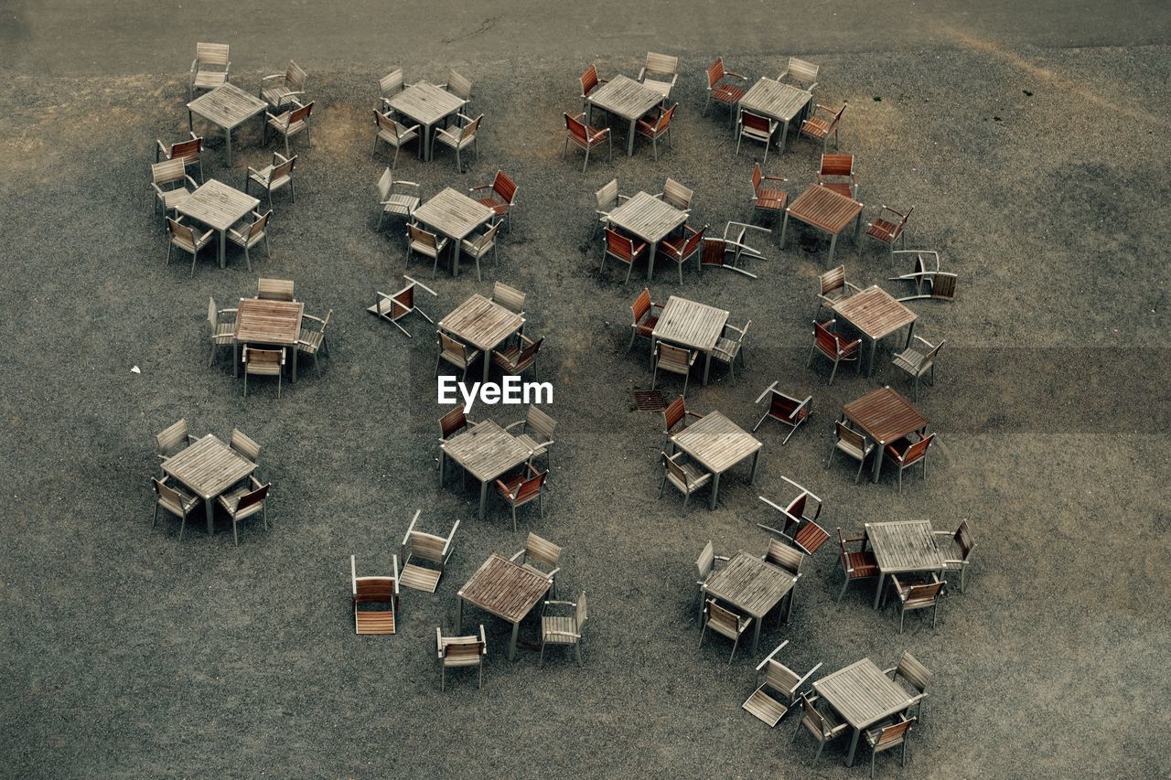High angle view of empty chairs and tables arranged on street