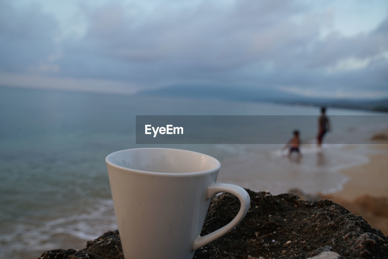 COFFEE CUP AGAINST SKY
