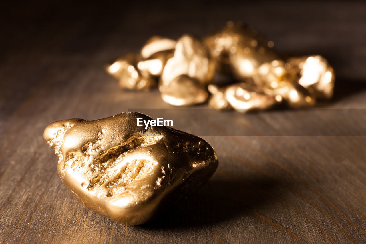 Close-up of golden nuggets on wooden table