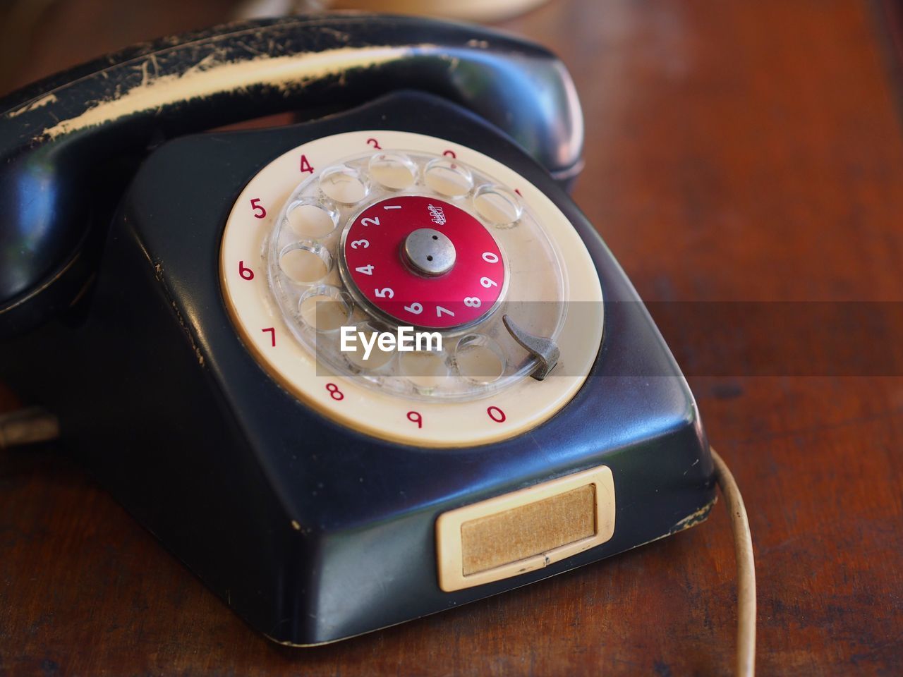 Close-up of old telephone on table