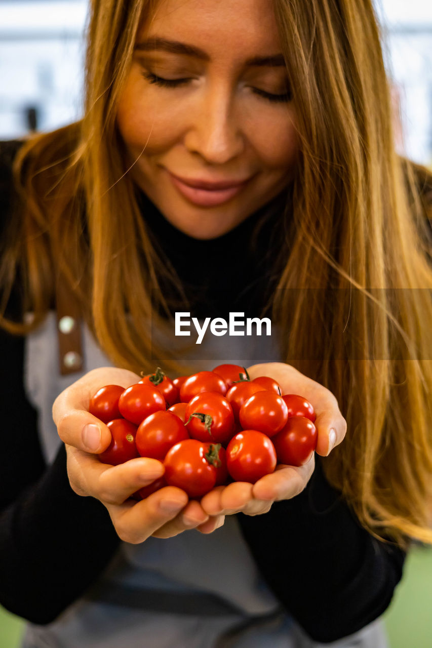 midsection of woman holding fruits