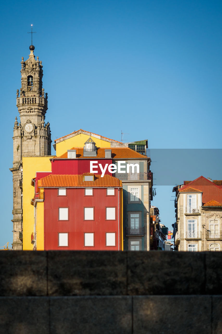 Colorful buildings and cathedral tower of the clerigos church in porto, portugal