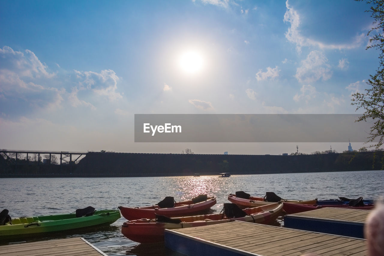 BOATS MOORED ON BRIDGE AGAINST SKY