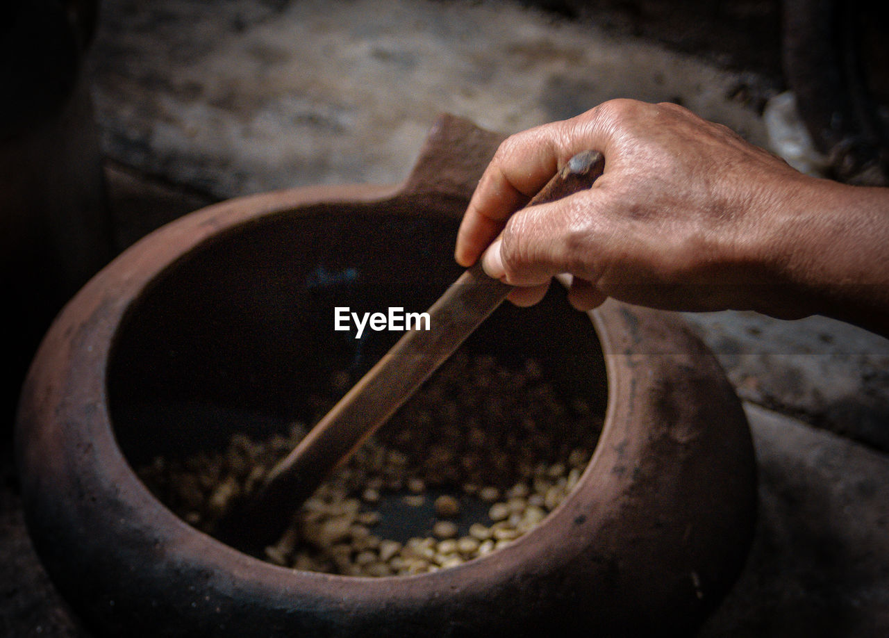 Cropped hand preparing food