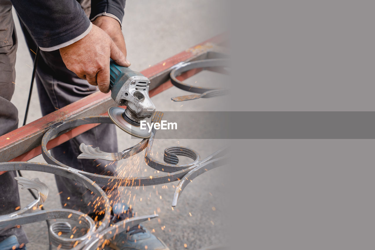 Metal grinding with angle grinder. sparks fly on the sides. male hand and instrument close-up. 