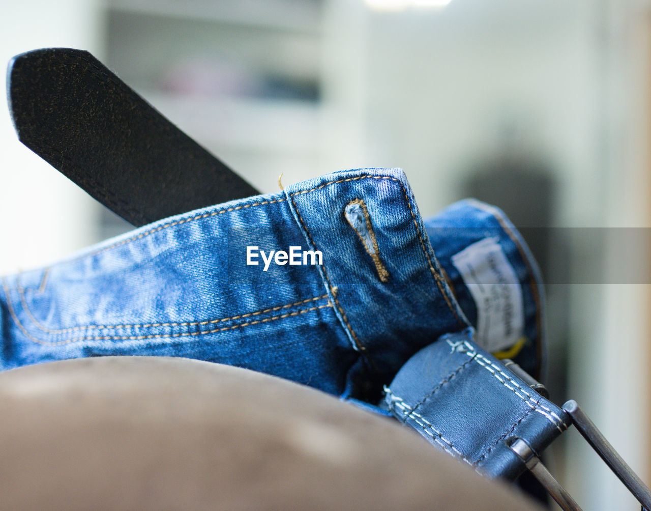 Close-up of jeans on seat at home