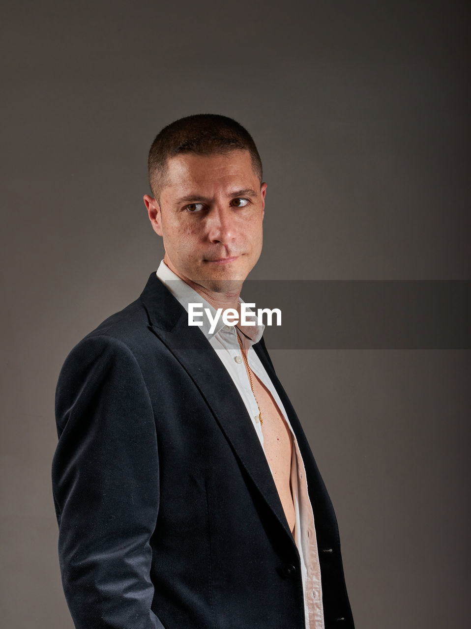 portrait, one person, adult, studio shot, men, looking at camera, formal wear, business, indoors, waist up, tuxedo, gray background, serious, gray, businessman, clothing, person, mature adult, standing, emotion, outerwear, business finance and industry, copy space, smiling, occupation, black