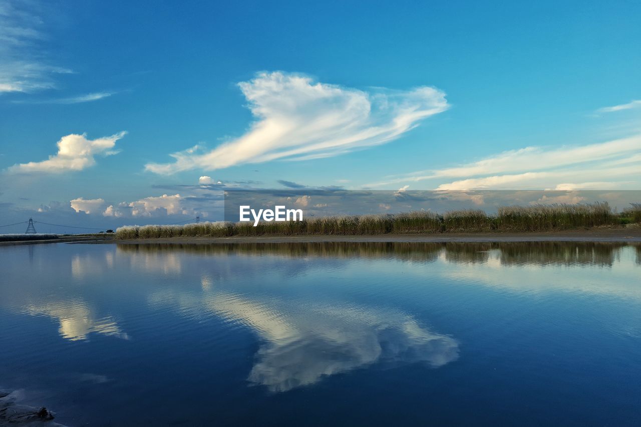 reflection, water, sky, cloud, scenics - nature, beauty in nature, tranquility, morning, nature, lake, tranquil scene, blue, dusk, environment, horizon, tree, body of water, landscape, no people, sunlight, plant, reservoir, travel destinations, outdoors, idyllic, non-urban scene, land, day, travel, sunrise, forest