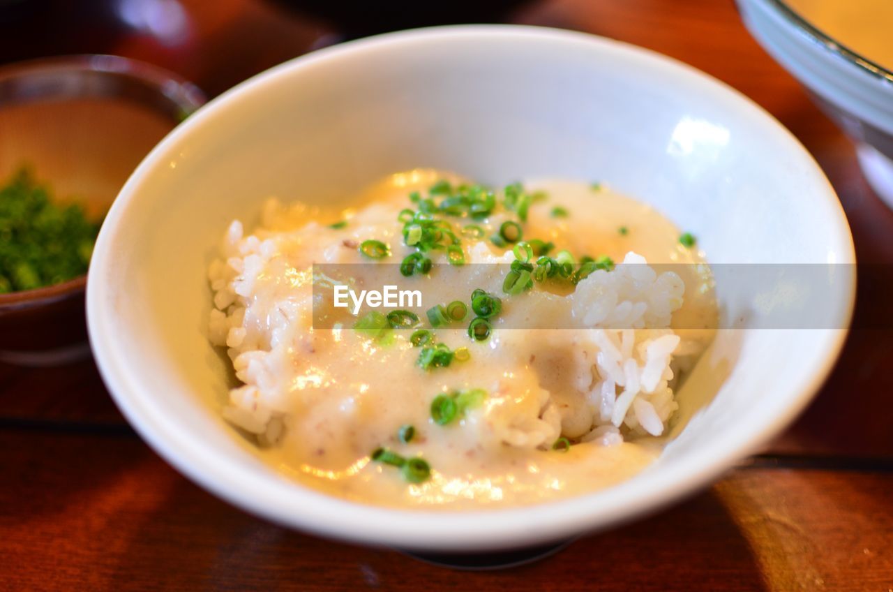 High angle view of rice and grated yam served in bowl on table