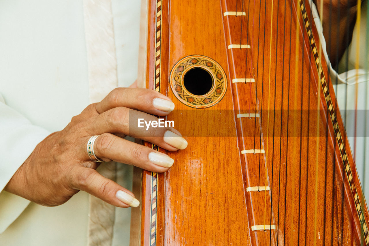 Close-up of woman playing harp