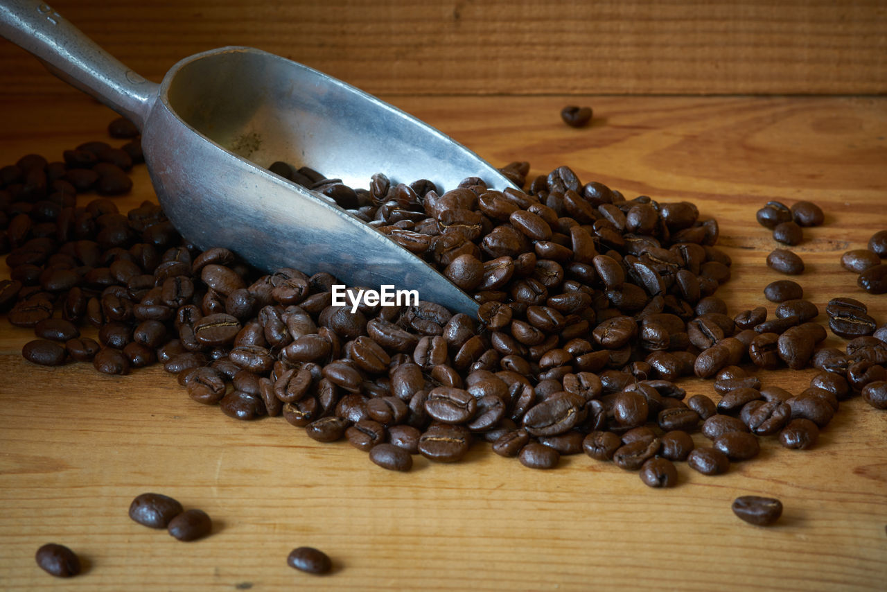 Close-up of roasted coffee beans on table