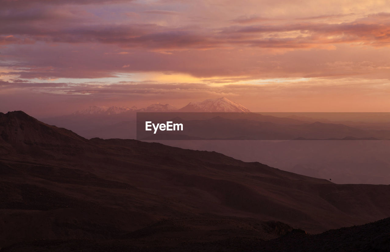 Scenic view of mountains against sky during sunset