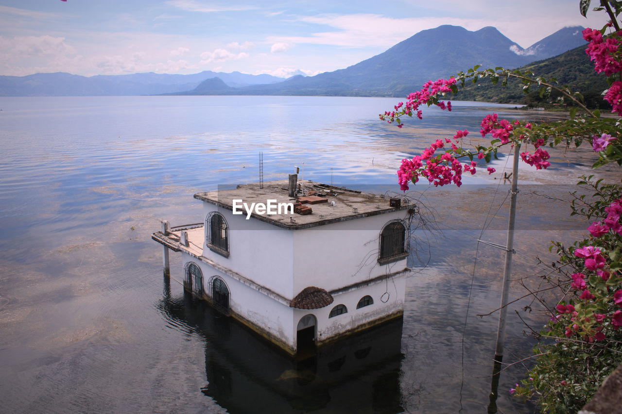 SCENIC VIEW OF LAKE WITH MOUNTAINS IN BACKGROUND