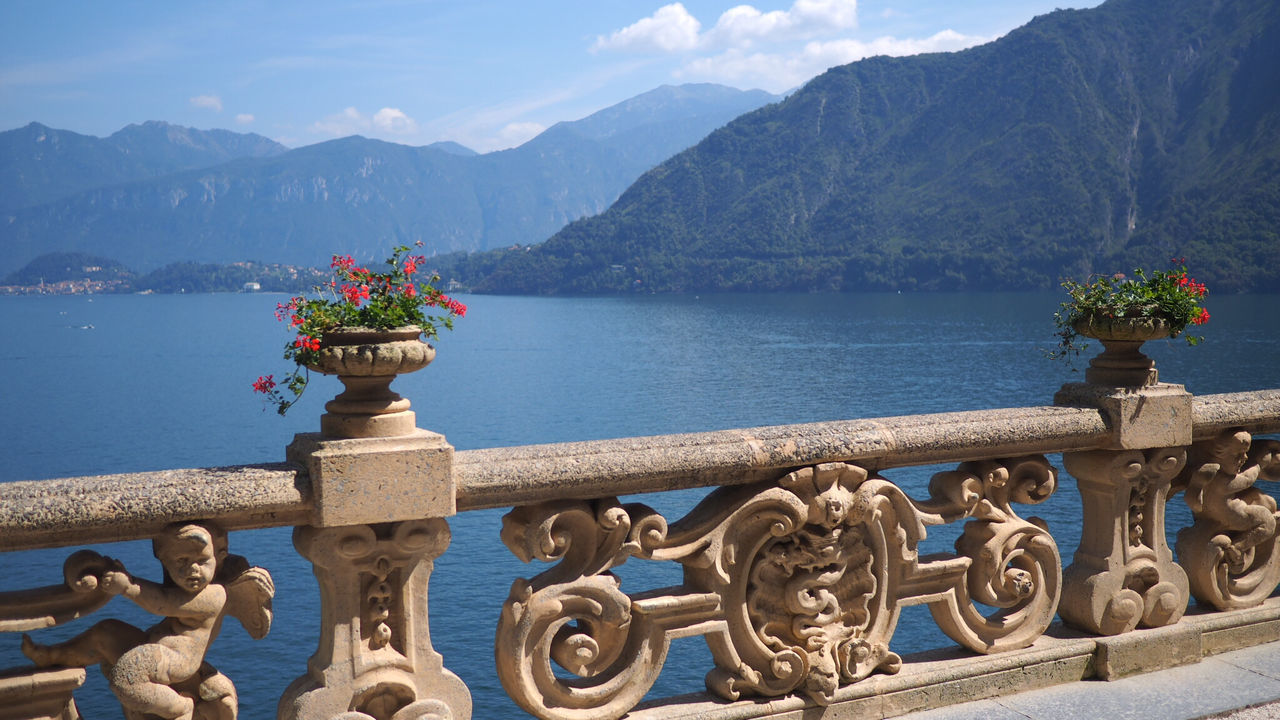 Calm lake against mountain range