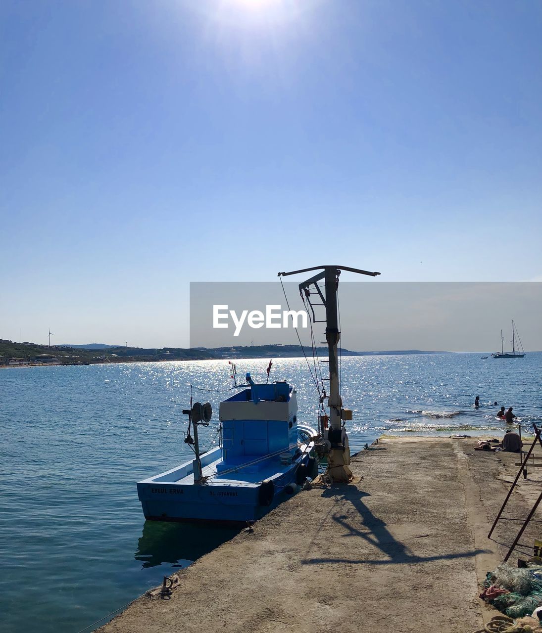 SHIP MOORED IN SEA AGAINST CLEAR SKY