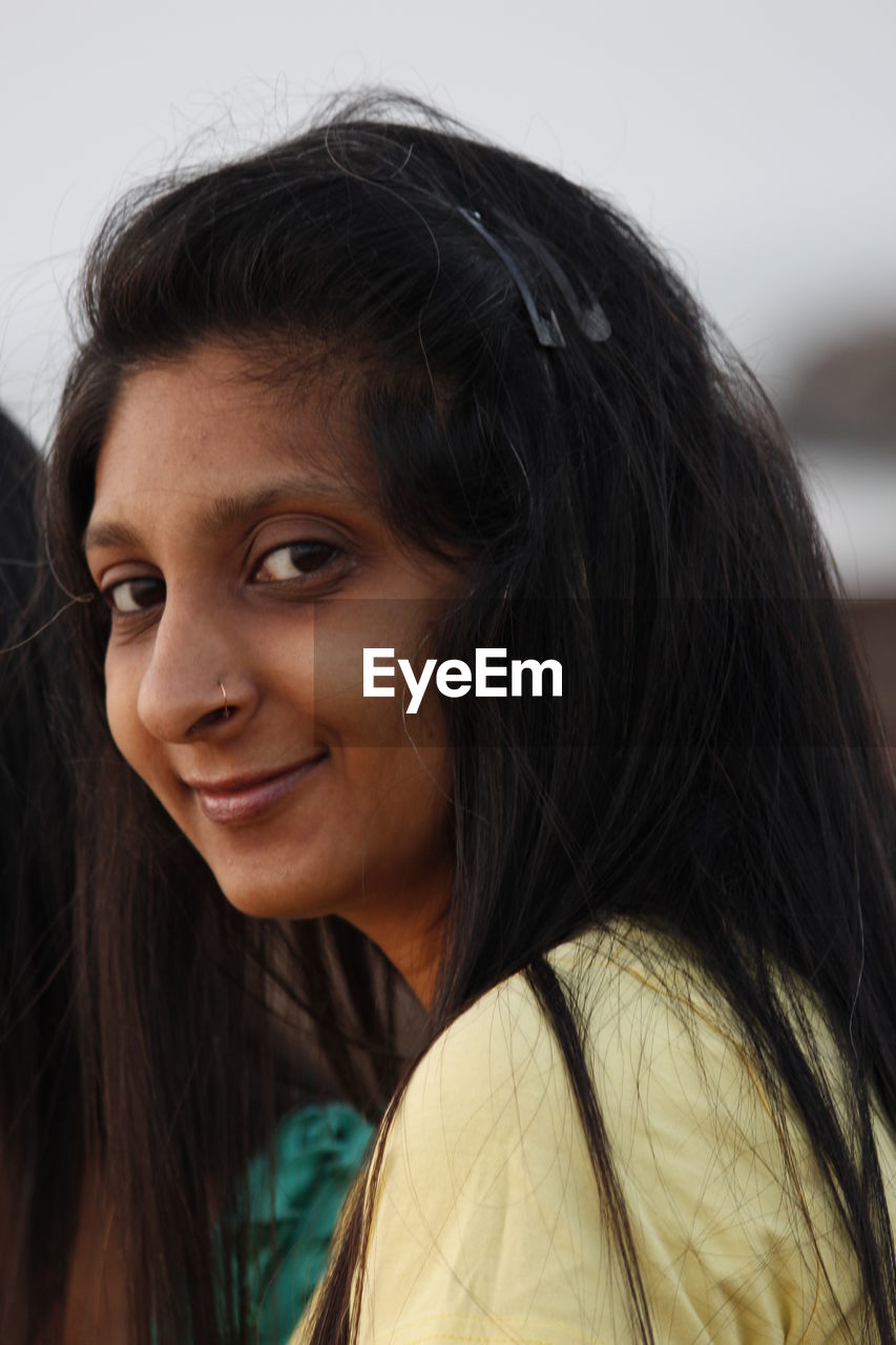 Close-up portrait of smiling young woman