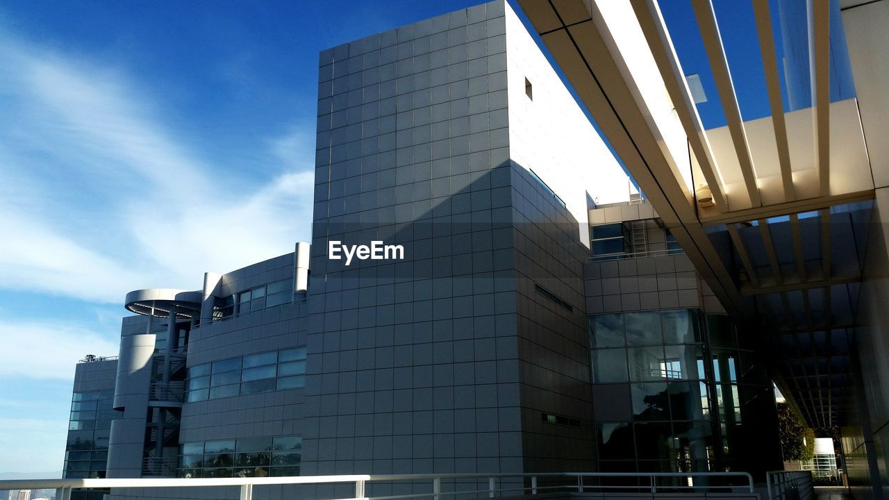 Low angle view of building against cloudy sky